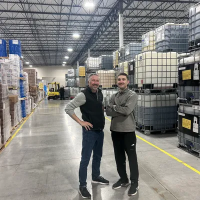 John and Evan Emard, founders of EmTech Oil, in a lubricants warehouse